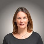 Portraitfoto von Katy Walther vor grauem Hintergrund.